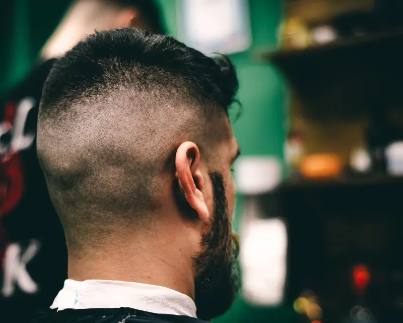 High skin fade with a full beard, freshly finished