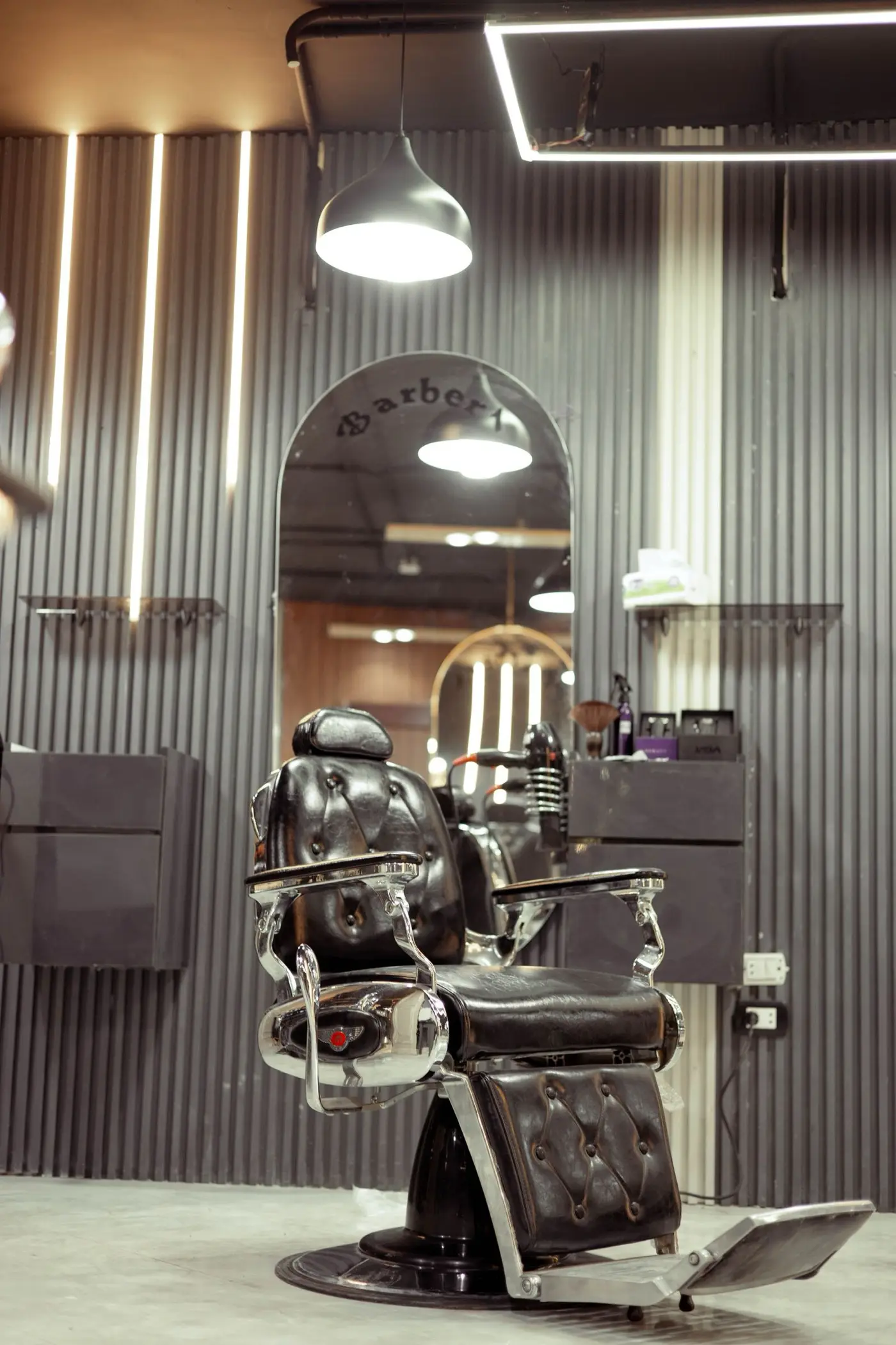 The vintage chair at Crown & Compass Barber Co., under a warm pendant light